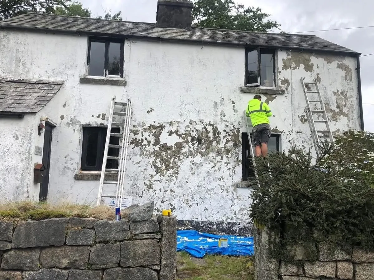 Cottage with blown, flaking render before repair in Kingsbridge